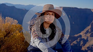 Young woman enjoying the incredibly impressive view over the majestic Grand Canyon