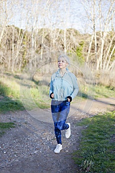 Young woman enjoying a jog along a country road