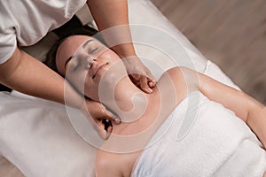 young woman enjoying massage in spa salon, head and neck massage, relaxing treatments in beauty salon, care, beauty and