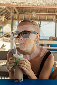 Young woman enjoying milkshake