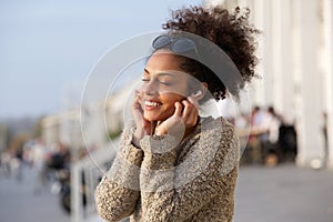 Young woman enjoying music on earphones