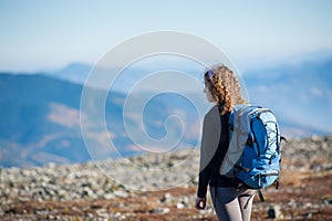 Young woman enjoying nature on backpacking trip in the mountains