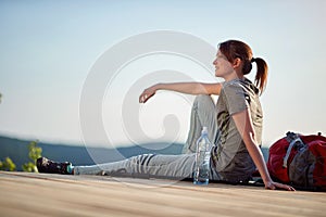 Young woman enjoying in nature at viewpoint high in mountain. nature, relaxing, leisure, positive,  energy concept