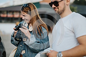 Young woman enjoying photography with a friend outdoors in a casual setting