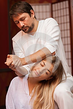 Young woman enjoying professional thai massage