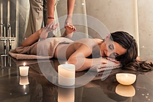 Young woman enjoying the stretching techniques of Thai massage photo