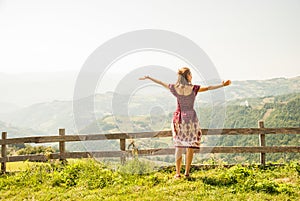 A young woman enjoying the sun on a meadow