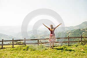 A young woman enjoying the sun on a meadow