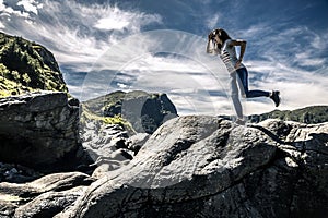 Young woman is enjoying the sunny day on the seaside of Norway