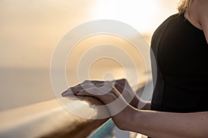 Close up of female hands on a cruise ship during sunset