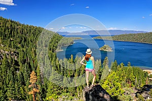 Young woman enjoying the view of Emerald Bay at Lake Tahoe, Cali