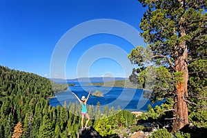 Young woman enjoying the view of Emerald Bay at Lake Tahoe, Cali