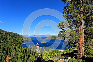 Young woman enjoying the view of Emerald Bay at Lake Tahoe, Cali