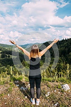 Young woman enjoying the view of a mountain range