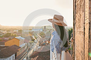 Young woman enjoying a view of the skyline of Granada in Nicaragua during sunset