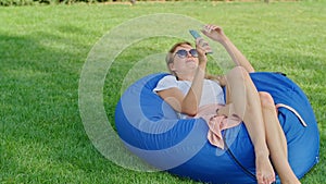 a young woman is enjoying a wonderful cool place in hot summer, having fun, falling on an ottoman, jumping, laughing
