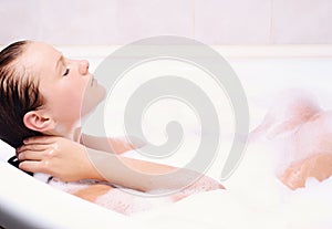 Young woman enjoys the bath-foam