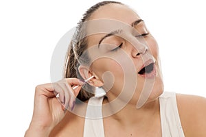 Woman cleaning her ears