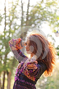 Young woman enjoys sun beams at spring park photo