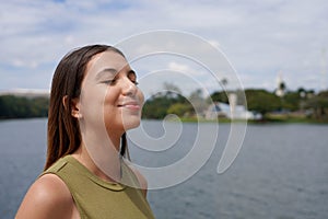 Young woman enjying breathing fresh air on Pampulha Lake, Belo Horizonte, Brazil