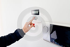 Young woman entering security code on keypad