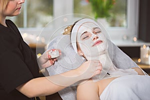 Young woman at enzymatic peeling therapy in spa photo