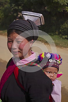 Young woman ethnic black Dao with her baby