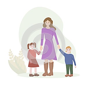 A young woman of European appearance with two children. The son and daughter hold the mother`s hand. The concept of motherhood and