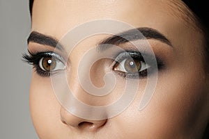 Young woman with evening makeup, closeup. Eye shadow product