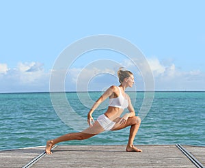Young woman excercising on the seaside
