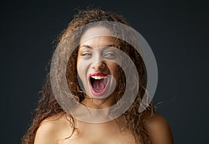Young woman excited and laughing with open mouth