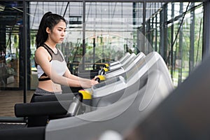 Young woman execute exercise in fitness center. female athlete w