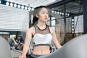 Young woman execute exercise in fitness center. female athlete w