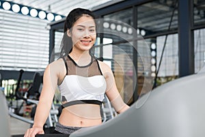 Young woman execute exercise in fitness center. female athlete w