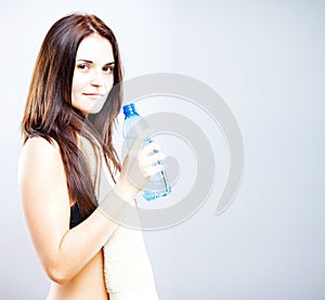 Young woman after exercise with bottle of water