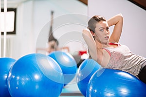 Young woman exercise with pilates balls