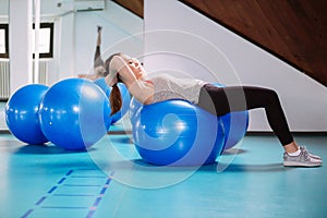 Young woman exercise with pilates balls