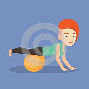 Young woman exercising with fitball.