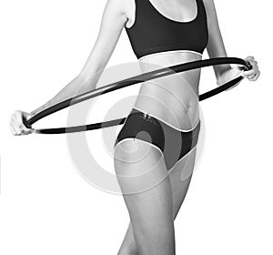 Young woman exercising with hula hoop