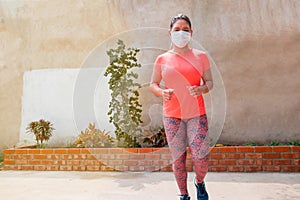 A young woman exercising inside during the quarantine, running during the confinement. Health, exercise, stay at home and self-