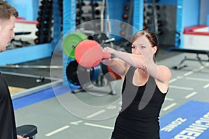 Young woman exercising with kettle bell weight