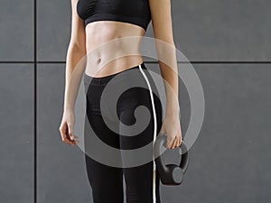 Young woman exercising with a kettlebell