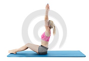 Young woman exercising on mat