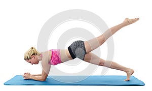 Young woman exercising on mat