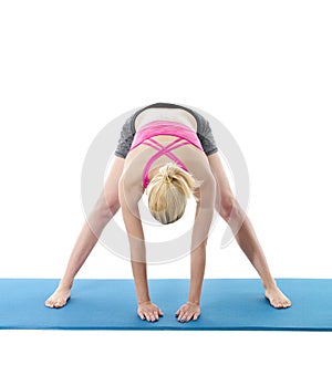 Young woman exercising on mat