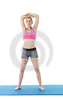 Young woman exercising on mat