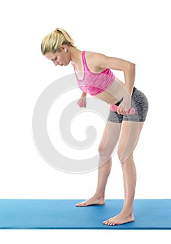 Young woman exercising on mat