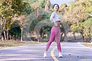 Young woman exercising in the morning at a public park on a bright sunny day