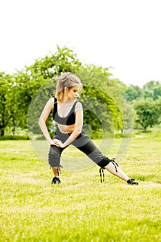 Young woman is exercising in the park.