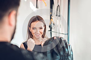 young woman exercising with personal trainer